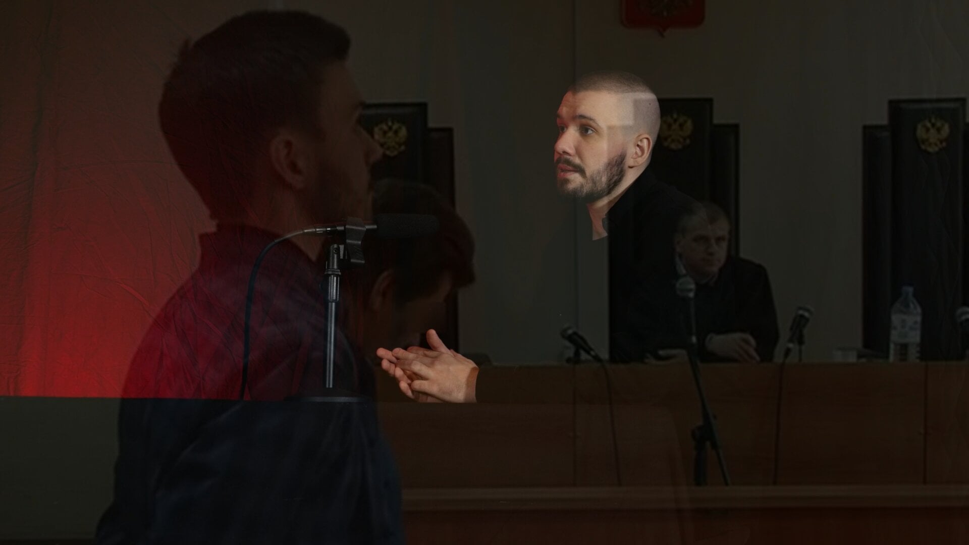 A photo of Vlad (Vladimir) Dorokhin with a background of Vladimir Dorokhin in the court for a participation in the protest called "He Is Not Our Tsar".
