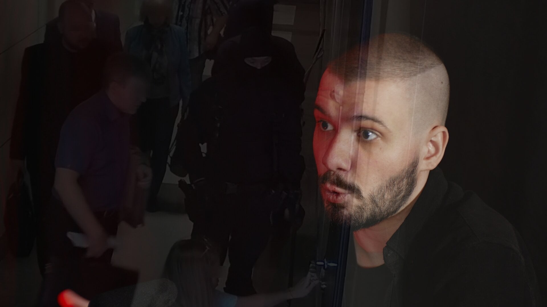 A photo of Vlad (Vladimir) Dorokhin with a background of Russian members of the secret service entering the Anti-Corruption Foundation office.
